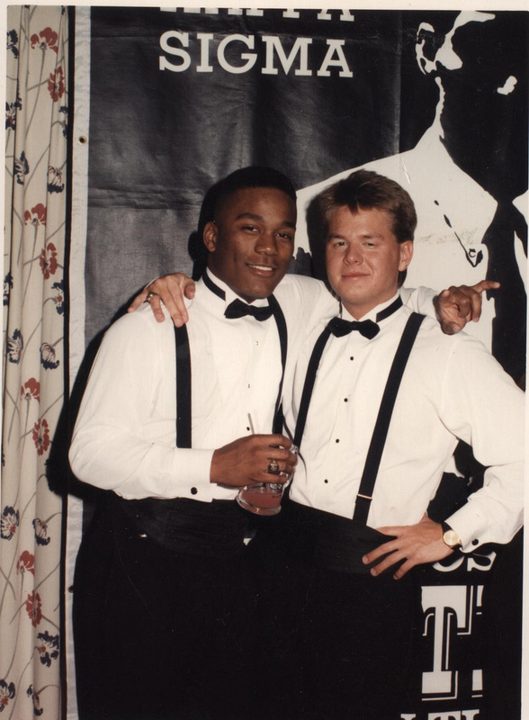 Two brothers in tuxedos under a Kappa Sigma banner